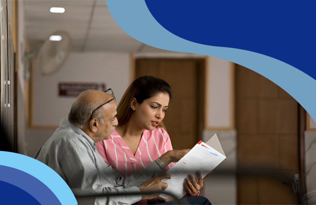 A woman and an elderly man seated together in a hospital room, reading health insurance plans